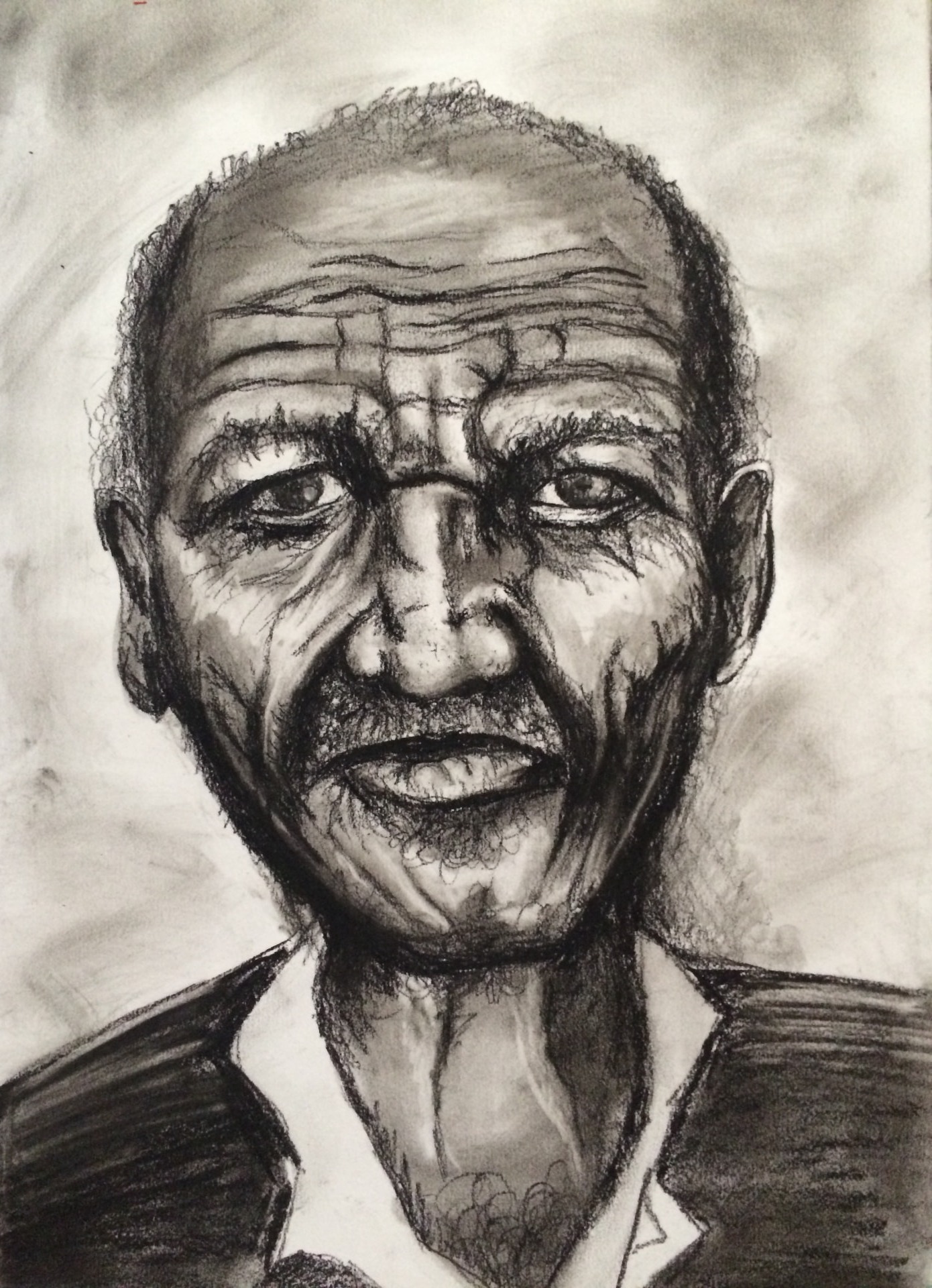 Charcoal portrait of an elderly man with a lined, expressive face