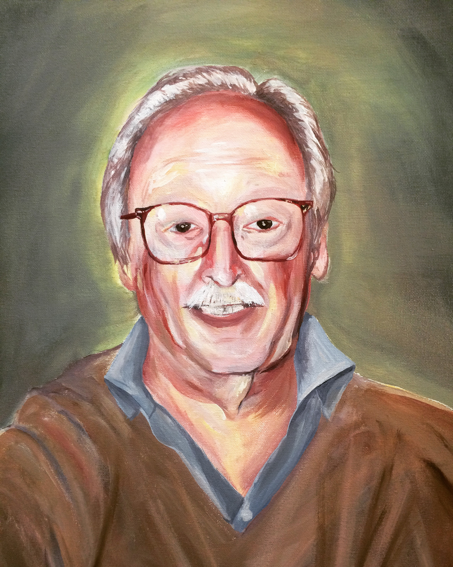 Portrait of a smiling older man with glasses and a brown jumper