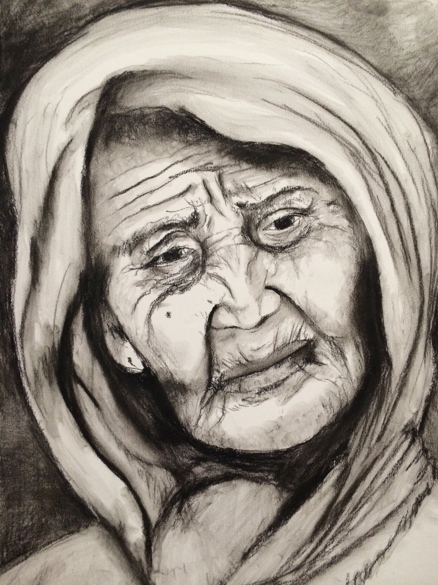 Charcoal drawing of an elderly woman wrapped in a shawl